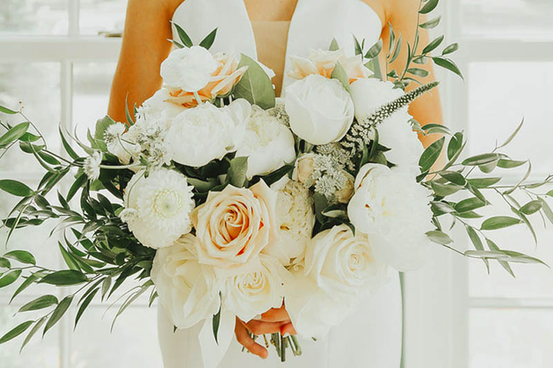A bouquet of white roses and peonies